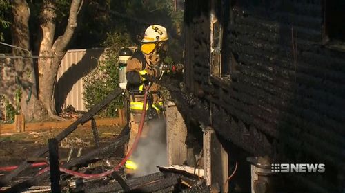 Fire crews battle the blaze on Currong Street in Kenmore. (9NEWS)