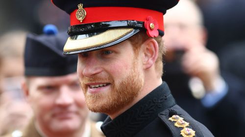 Britain's Prince Harry speaks to members of the armed forces and their and relatives during his visit to the Field of Remembrance at Westminster Abbey in central London, Britain. (AAP)