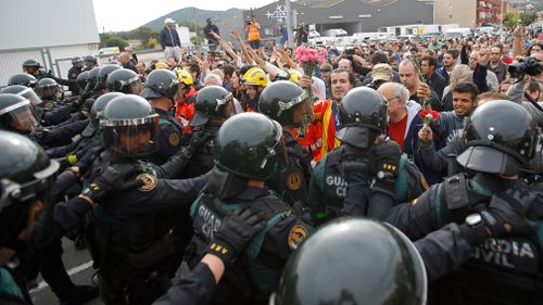 People block the street in a stand off with civil guards in Sant Julia de Ramis. (AP)