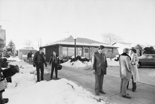 Police are seen on December 22, 1978, surrounding the home of the serial killer John Wayne Gacy.