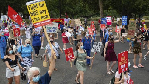 National Health Service (NHS) workers march from St. James' Park to Downing Street, London, Saturday Aug. 8, 2020, as part of a national protest over pay