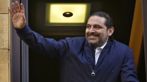 Lebanon Prime Minister Saad Hariri waves to supporters outside his home. (AAP)