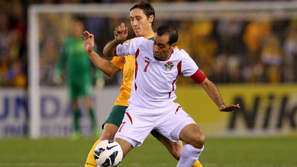 Socceroos midfielder Mark Milligan battles a Jordanian player for possession.(Getty)
