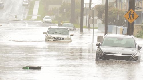 Cars swallowed by floodwaters in Wollongong.