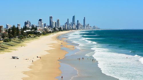 Surfers Paradise swimmer pulled from water, treated by paramedics