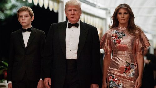 President Donald Trump arrives for a New Year's Eve gala at his Mar-a-Lago resort with first lady Melania Trump and their son Barron, Sunday, Dec. 31, 2017, in Palm Beach, Fla. (AP Photo/Evan Vucci)