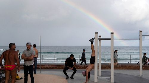 People exercise at the outdoor gym in Bondi Beach during a state-wide lockdown. People are permitted to leave the house for four essential reasons, including physical activity.