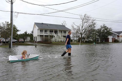 A woman pulls her daughter along in a boat in Davis, North Carolina.