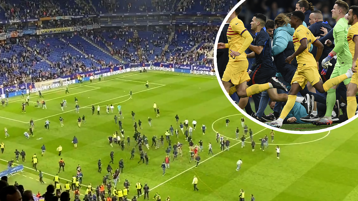 Players and staff from Barcelona are forced to flee the field after opposing fans stormed the pitch.