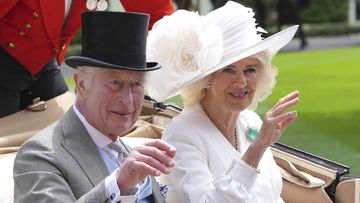 Britain&#x27;s King Charles III and Queen Camilla wave to the crowds as they arrive by carriage in the parade ring on the third day of the Royal Ascot, horse race meeting, traditional known as Ladies Day, at Ascot, England, Thursday, June 20, 2024. (AP Photo/Kin Cheung)