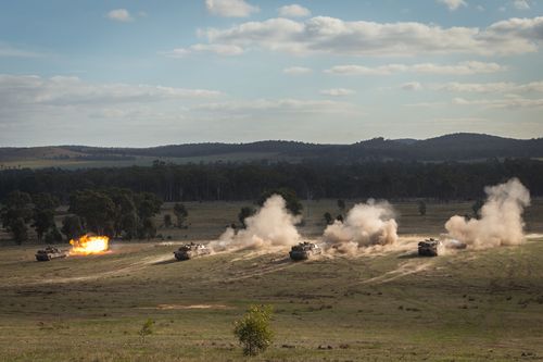 Australian Army tanks firing at targets during exercises at Puckapunyal training area.