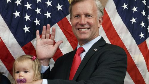 FILE - Congressman Chris Jacobs, R-N.Y., centre, poses for a photo with his daughter Anna, 1, during a ceremonial swearing-in on Capitol Hill, July 21, 2020, in Washington. Jacobs says he will not run for another term in Congress amid backlash over his support for new gun control measures. (AP Photo/Jacquelyn Martin, File)
