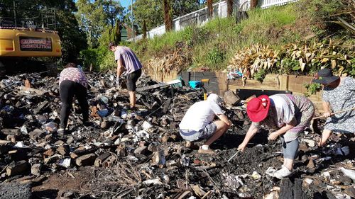 Tambourine Mountain residents search the rubble for personal effects. (9NEWS/Ehsan Knopf)