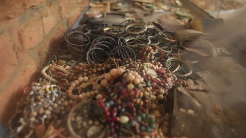 Jewellery belonging to victims as they sought refuge placed on the altar, as a memorial to the thousands who were killed during the 1994 genocide in and around the Catholic church, in Nyamata, Rwanda.