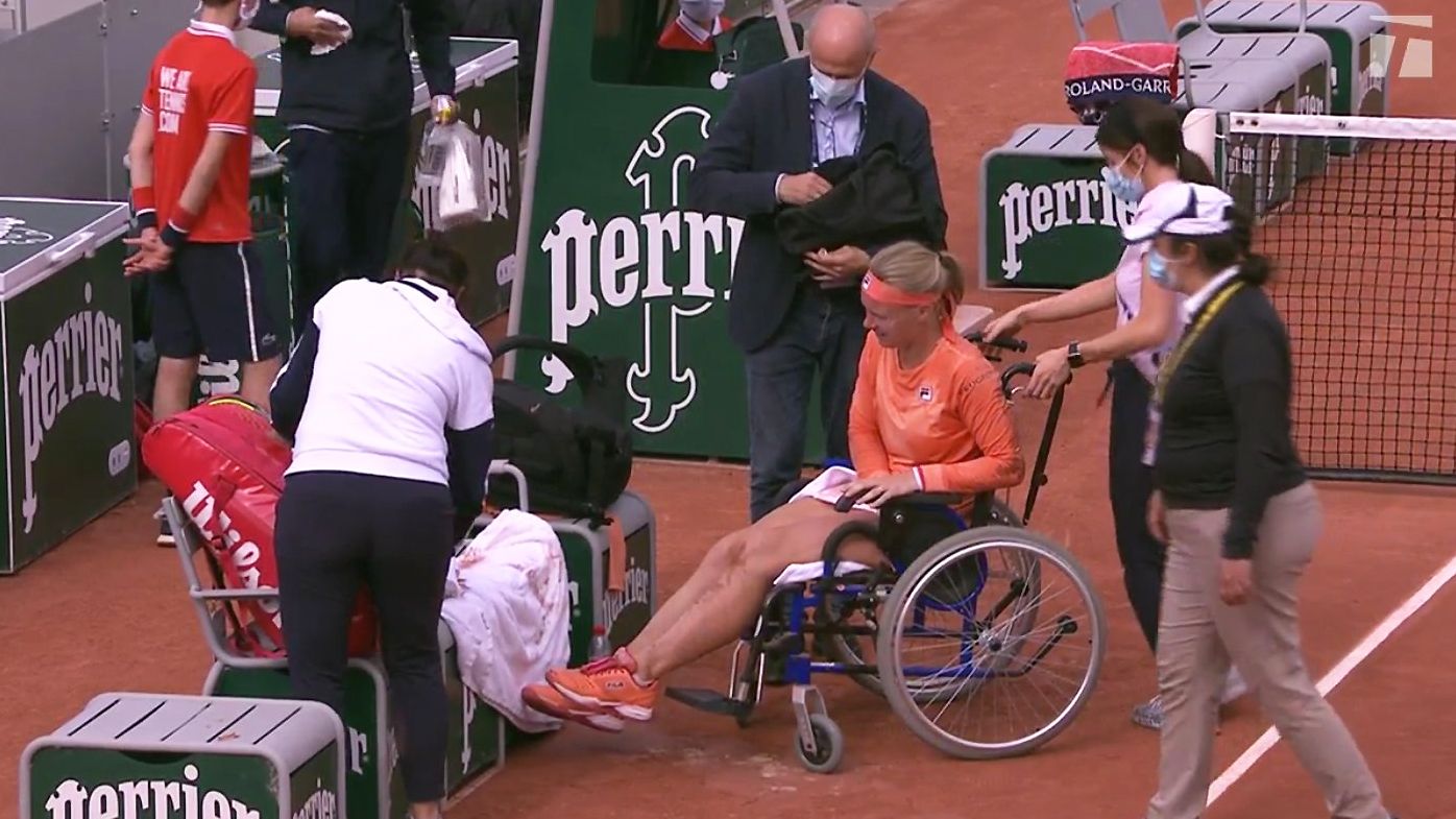 Bertens receives treatment on a wheelchair at the French Open