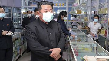Kim Jong-un visits a pharmacy in Pyongyang in May.