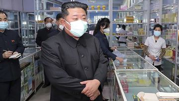 Kim Jong-un visits a pharmacy in Pyongyang in May.