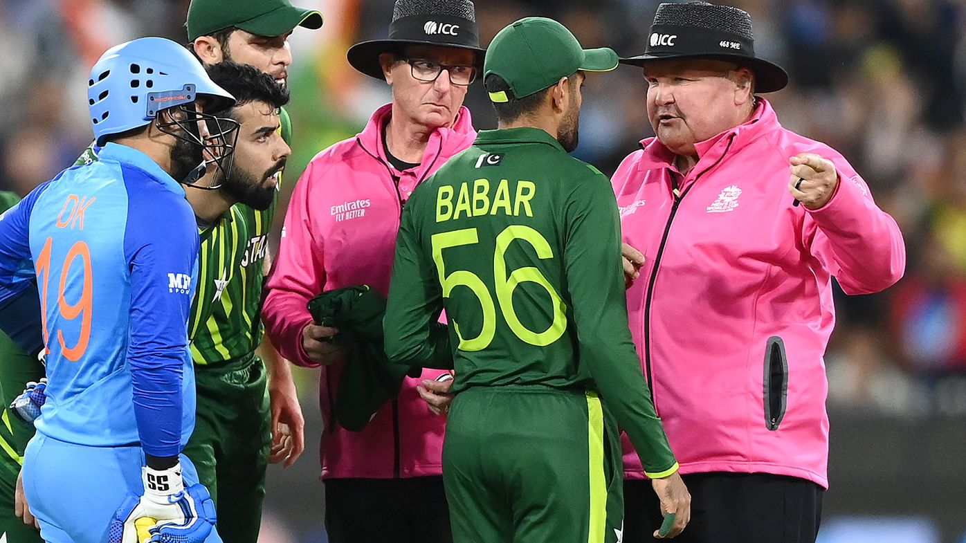 Pakistan&#x27;s Babar Azam talks to the umpires during a chaotic final over of the T20 World Cup match against India.