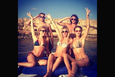 The Victoria's Secret beauty Instragrammed herself on a girls' island holiday: 'Love & peace from Ibiza @leezabe @annachristinhaas @jak_th @theohurts.'