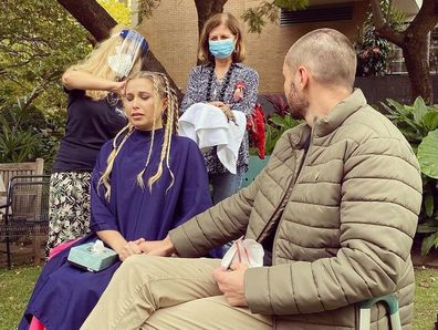 Simon held Hannah's hand as her head was shaved to make a wig.