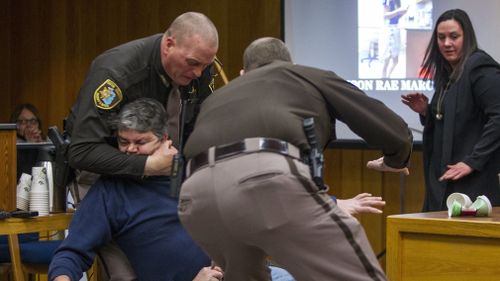 Eaton County Sheriff's deputies restrain Randall Margraves. (AAP)