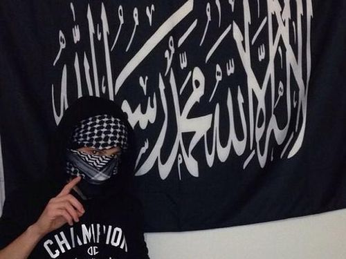 A teenage boy poses with the Mohammad's flag of Jihad (Instagram). 