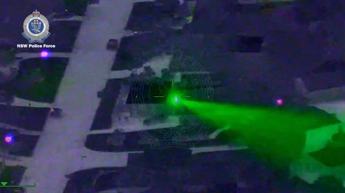 A man has been charged after allegedly pointing a laser at a police helicopter