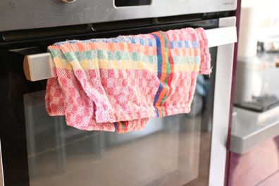 Tea towel hanging on oven door handle