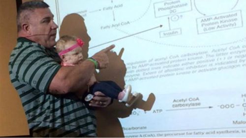 US university professor doubles as baby-sitter during lecture
