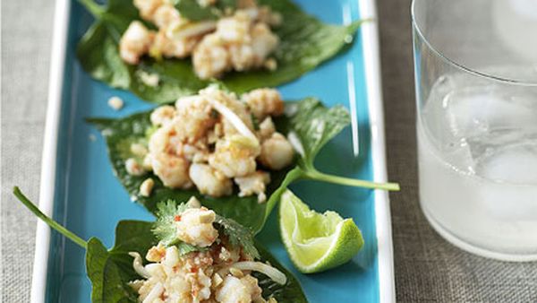 Betel leaves topped with prawns and galangal