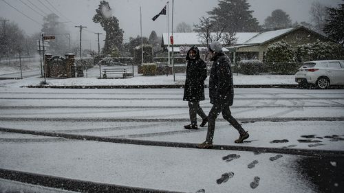 People walk in snow in Blackheath in the NSW Blue Mountains.