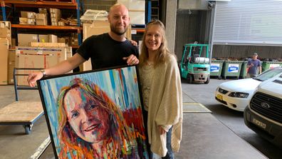 Joe Lander and subject Jennie Hudson deliver his Archibald Prize entry.