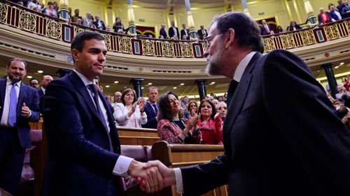 Spain's Prime Minister Mariano Rajoy shakes hands with socialist leader Pedro Sanchez after a motion of no confidence vote at the Spanish parliament. Picture: AP