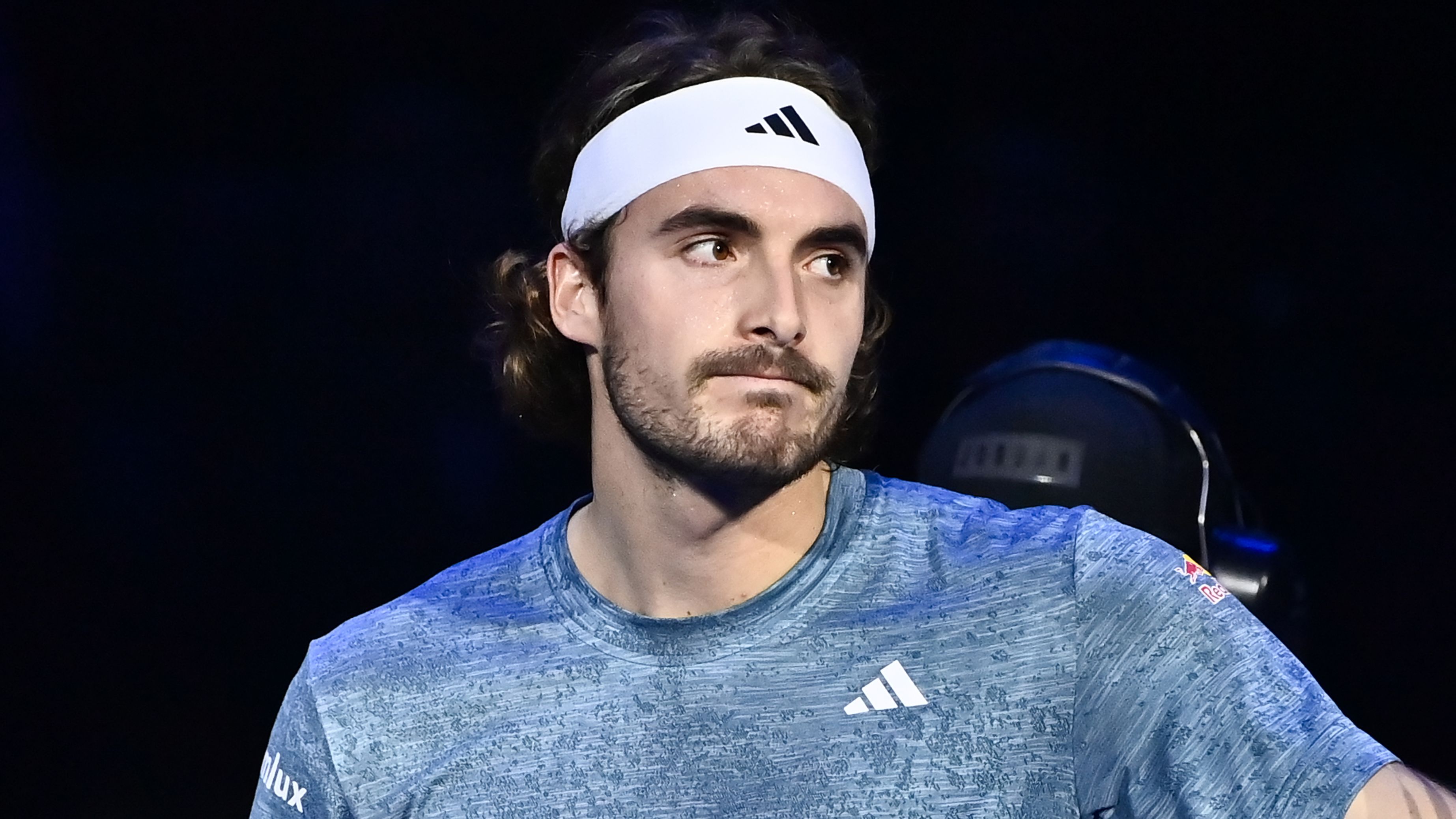 Stefanos Tsitsipas reacts after abandoning his game with Holger Rune because of a back injury.