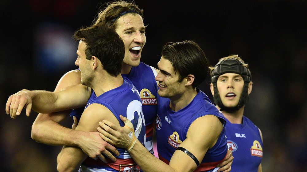 The Bulldogs celebrate after defeating the Hawks.(AAP)