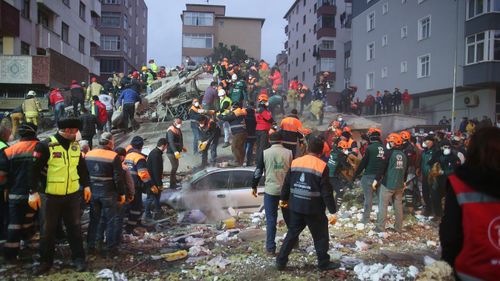 Rescuers work at the site of a collapsed building in Kartal district of Istanbul, Turkey.
