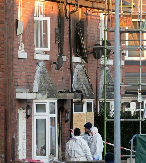 Forensic officers at the scene of the house fire on Jackson Street in Worsley, Greater Manchester.