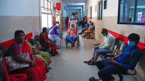 A patient infected with black fungus is taken on a wheelchair for treatment at the mucormycosis ward of a government hospital in Hyderabad, India