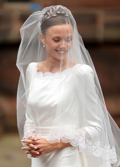 CHESTER, ENGLAND - JUNE 07: Olivia Henson smiles as she arrives for her wedding to Hugh Grosvenor, Duke of Westminster at Chester Cathedral on June 07, 2024 in Chester, England. (Photo by Chris Jackson/Getty Images)