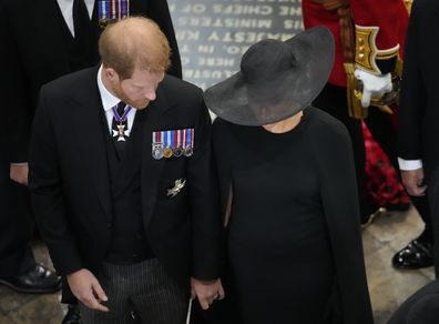 Prince Harry and Meghan Markle, the Duchess of Sussex, follow the coffin of Queen Elizabeth II as it is carried out of Westminster Abbey
